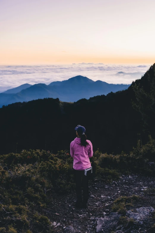 the woman is walking down a hill alone