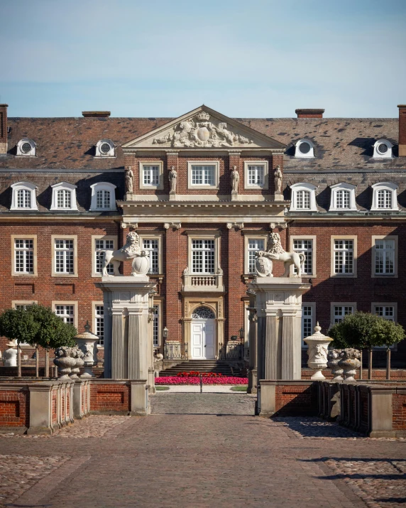 a large building with statues on it next to some trees