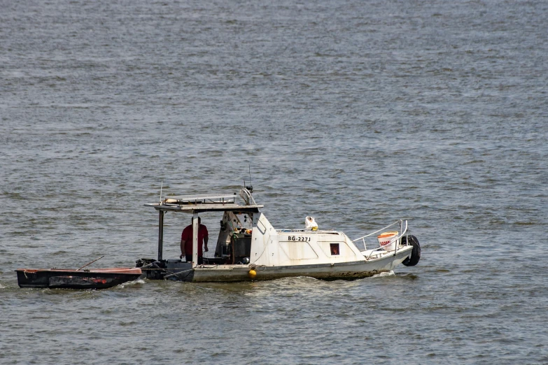 a white boat with a motor sitting in the middle of the water