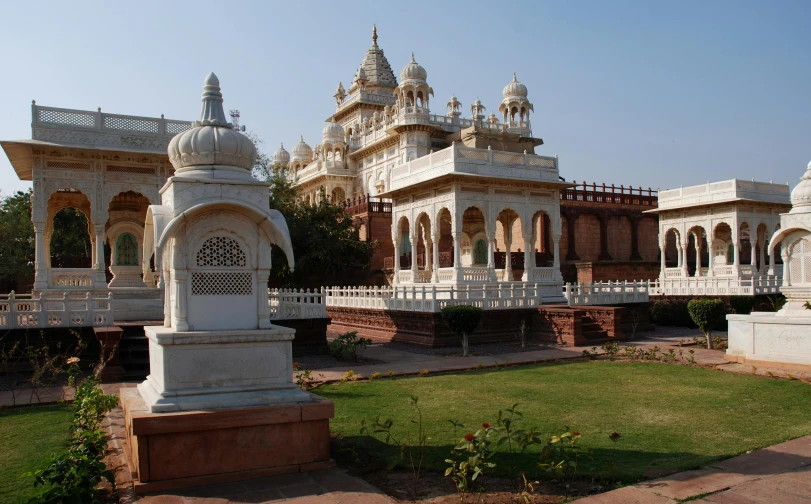 white sculptures in a park setting with other white structures