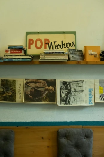 a room with posters on the wall and a large shelf