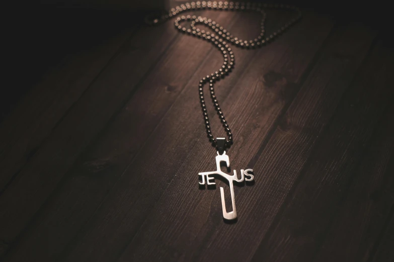 a cross is on the floor near a chain