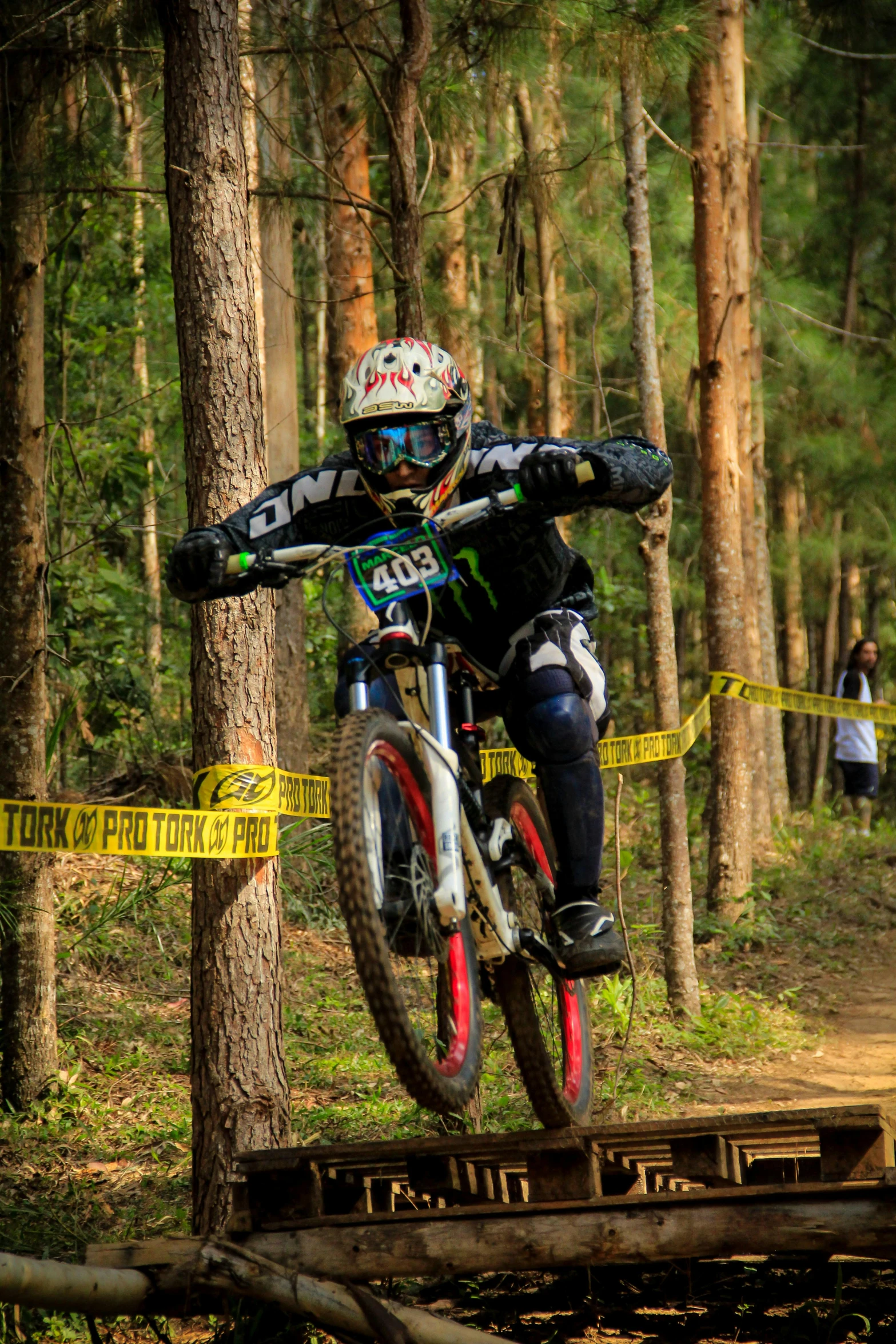 a person jumping a bike in the air above a trail