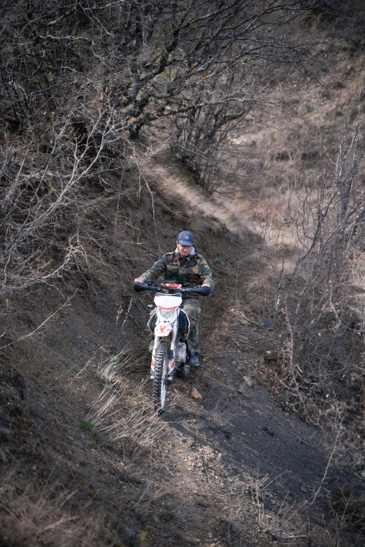 a man riding on the back of a dirt bike