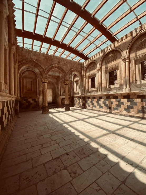 an empty ballroom with tiled floor and vaulted ceiling