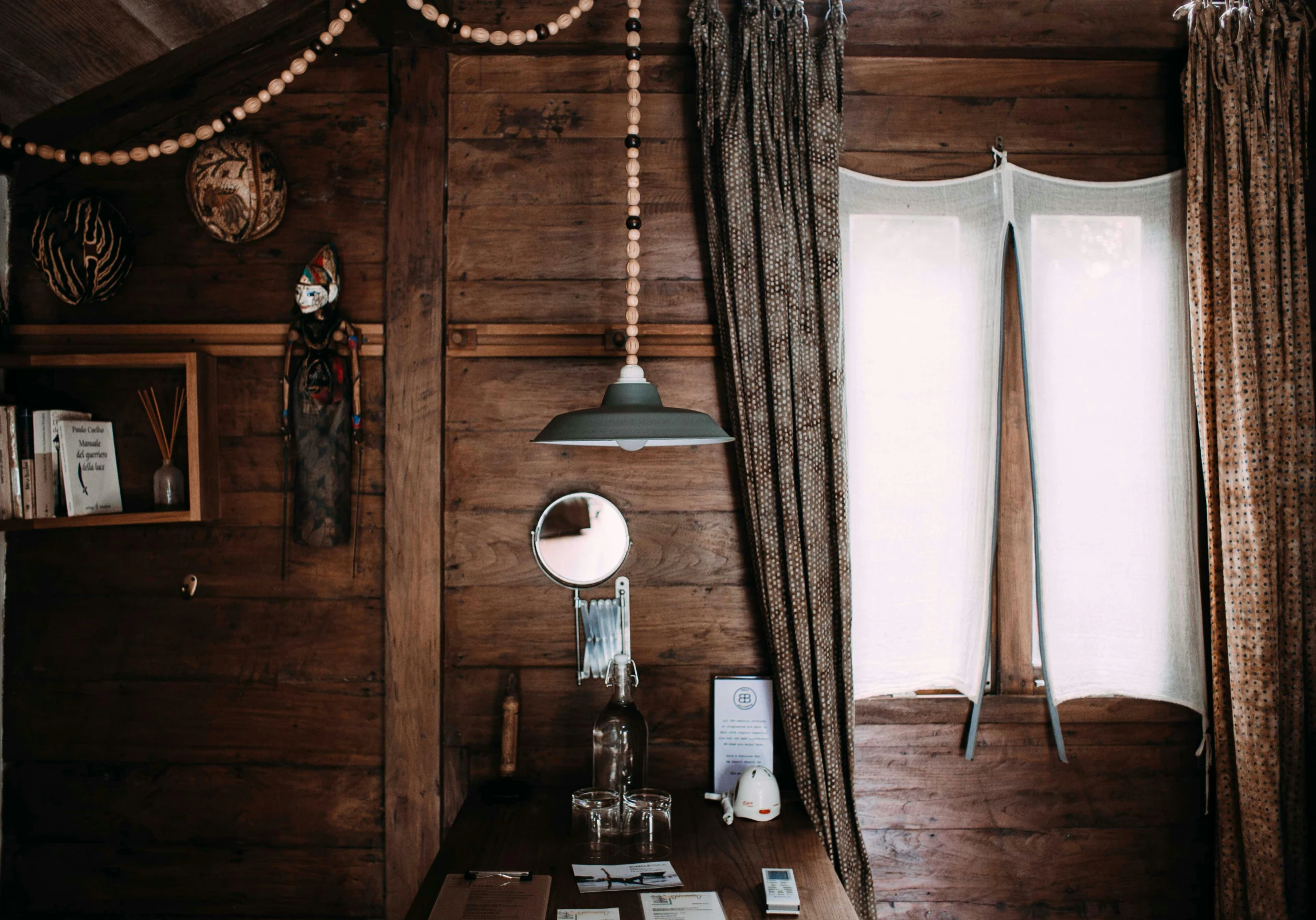 a brown wood cabin bedroom with a desk