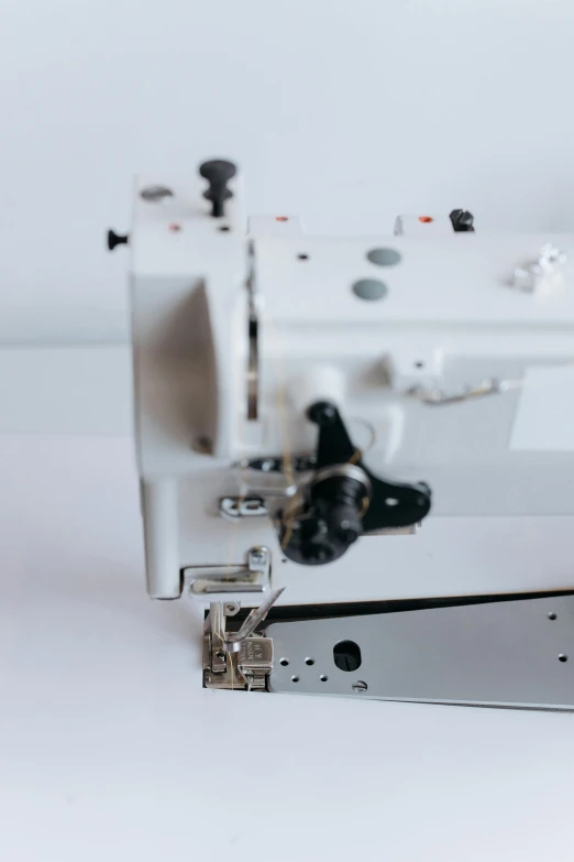 a sewing machine with many pieces of black stitching