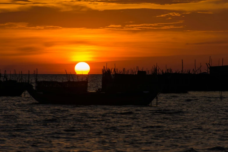 a sunset over a harbor with boats docked