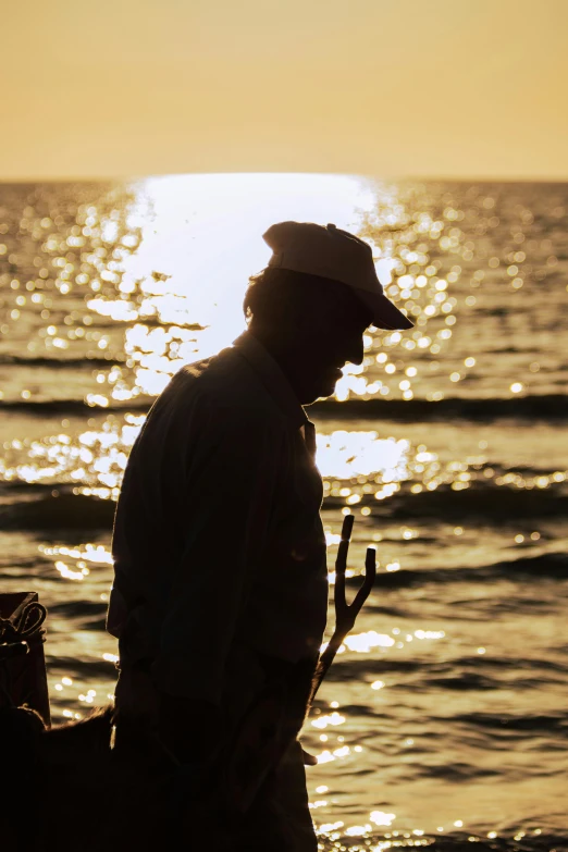 a man standing on a beach next to the ocean