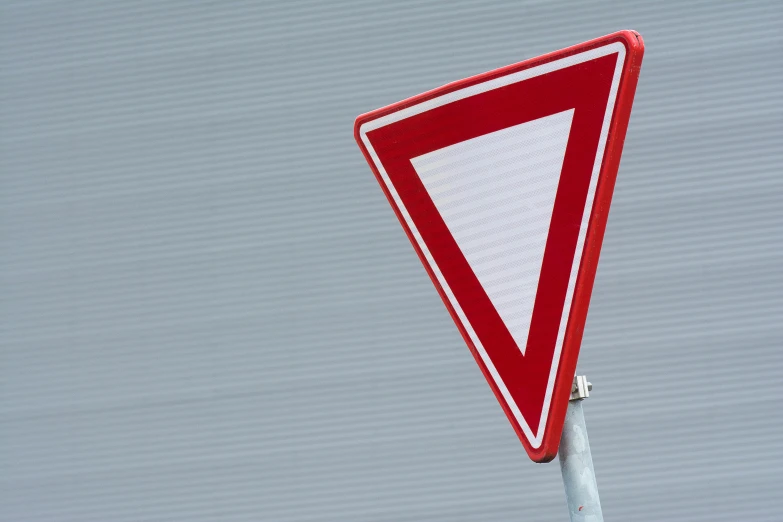 a street sign is shown with a red triangle in the center