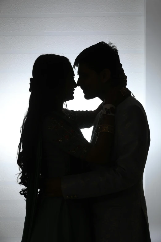 a bride and groom are standing side by side