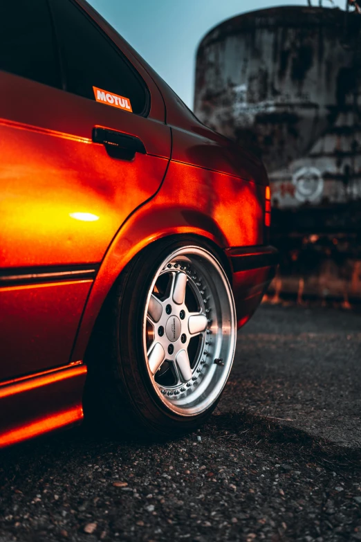 a red car that is parked in the street