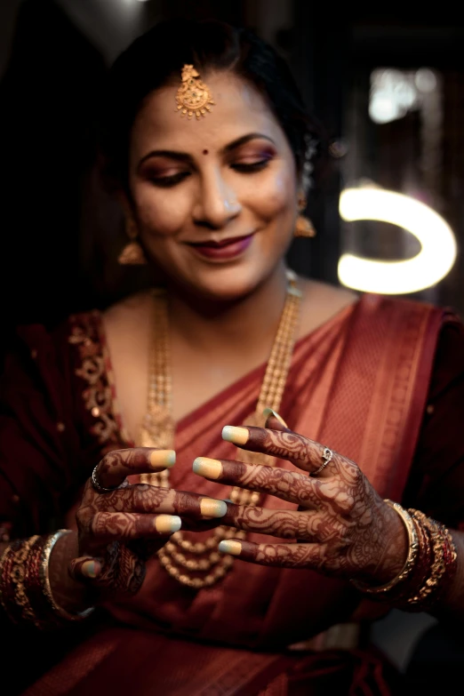 a smiling indian bride holding her hands together