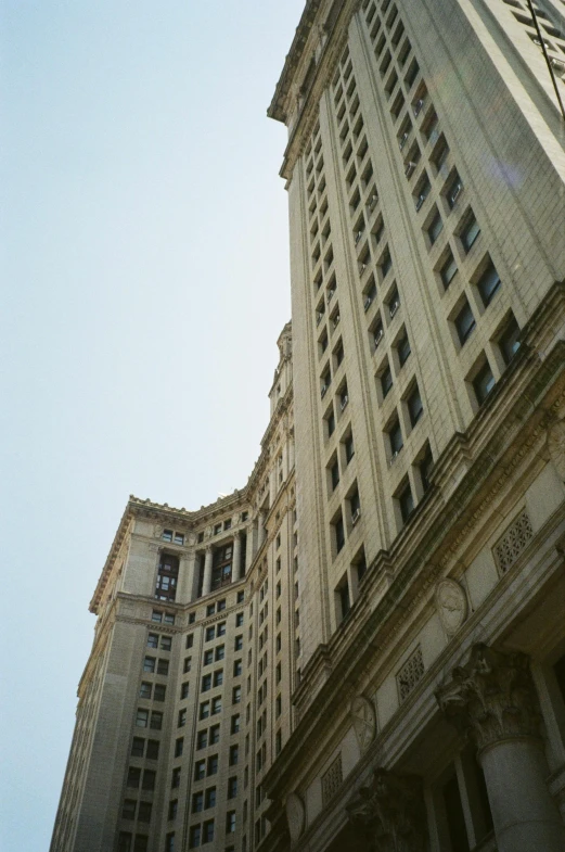 a very tall white building towering above another building