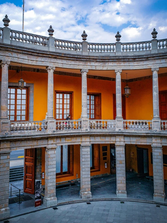 an empty building with a balcony and lots of windows