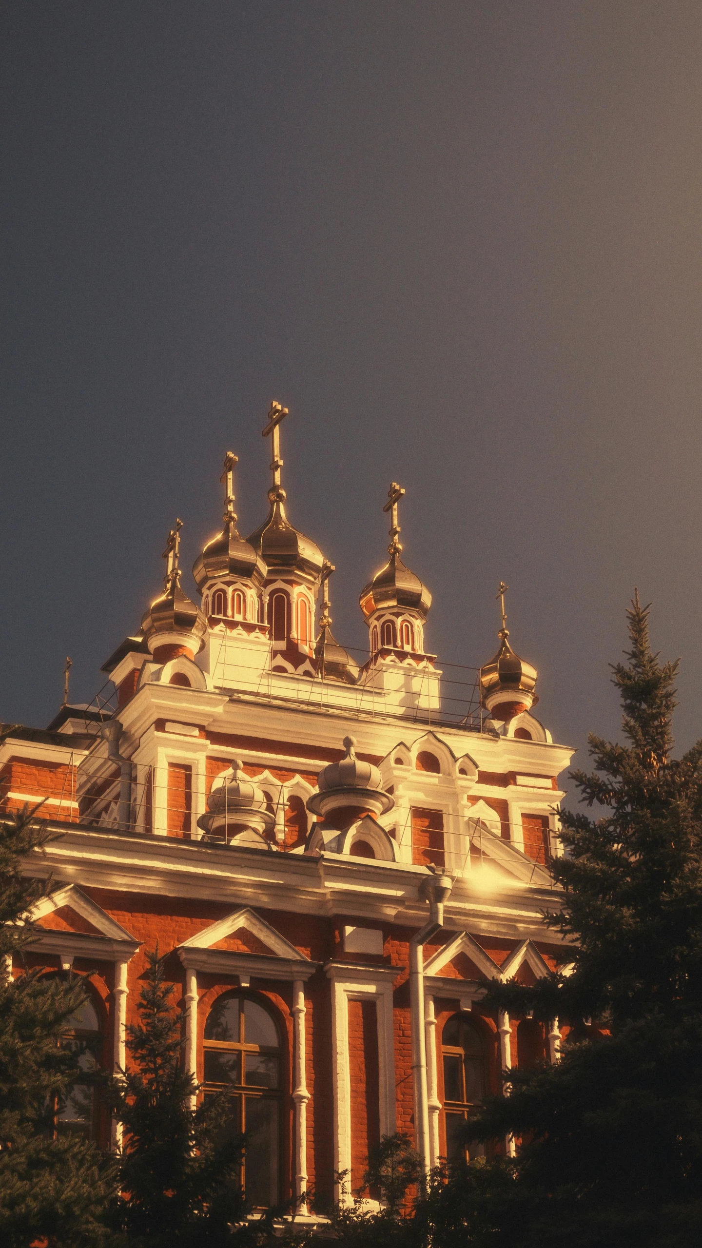 a building with lots of windows and towers in the evening