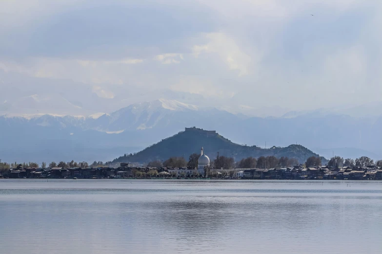 a view of the mountains and sea shore