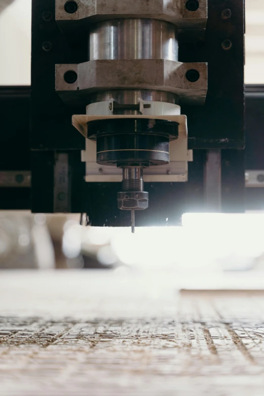 a metal  machine that is on a wooden table