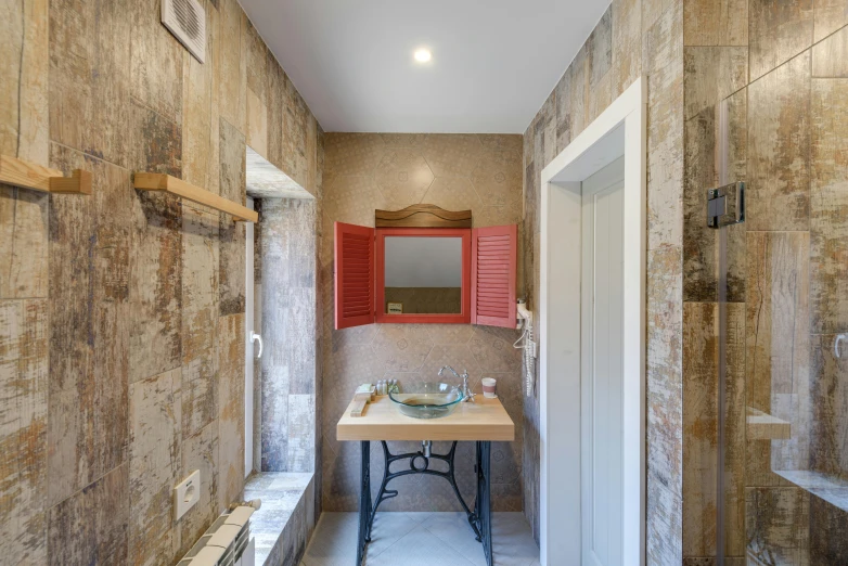 the large bathroom has stone and red cabinets