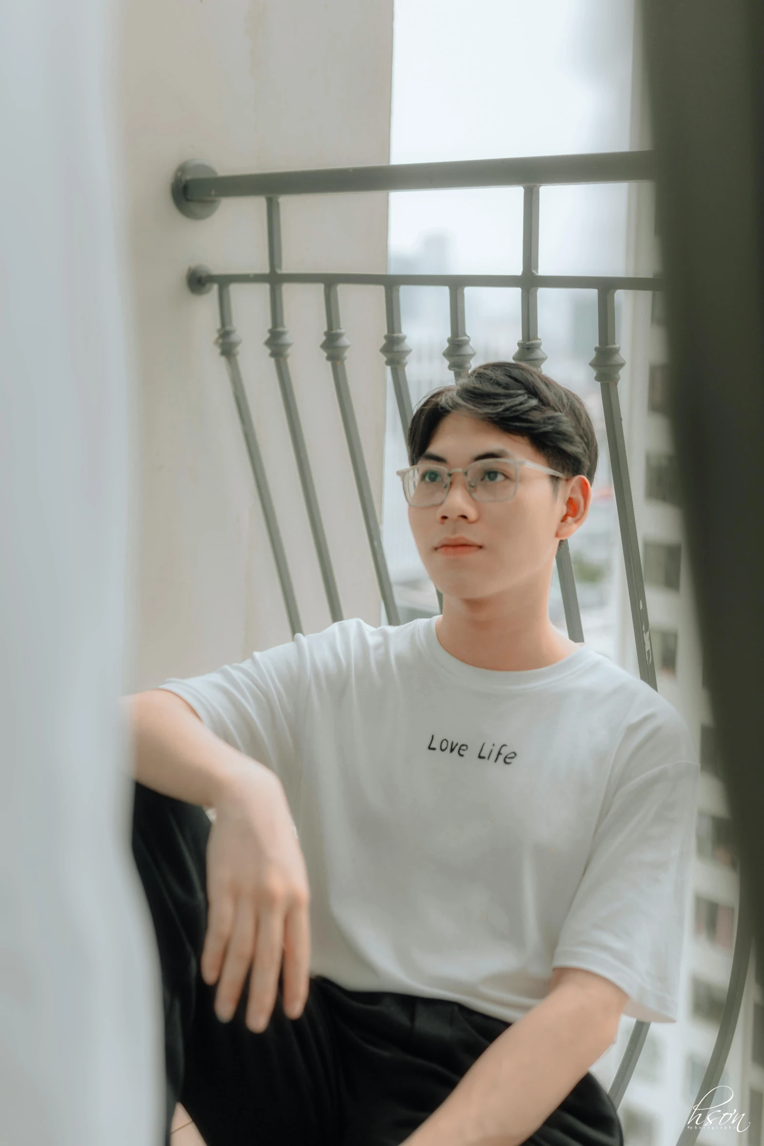 a man sitting next to a metal door