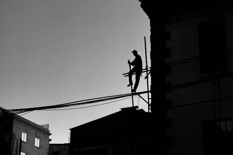 a black and white po of an electric worker on a high wire