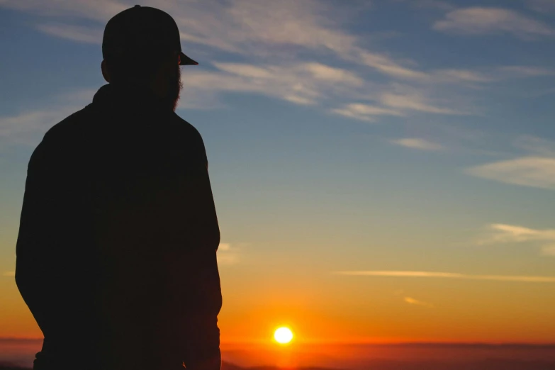 a person is standing in front of the sun