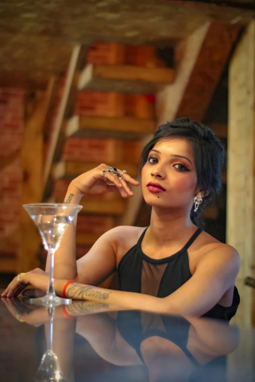 the young woman is sitting at the bar