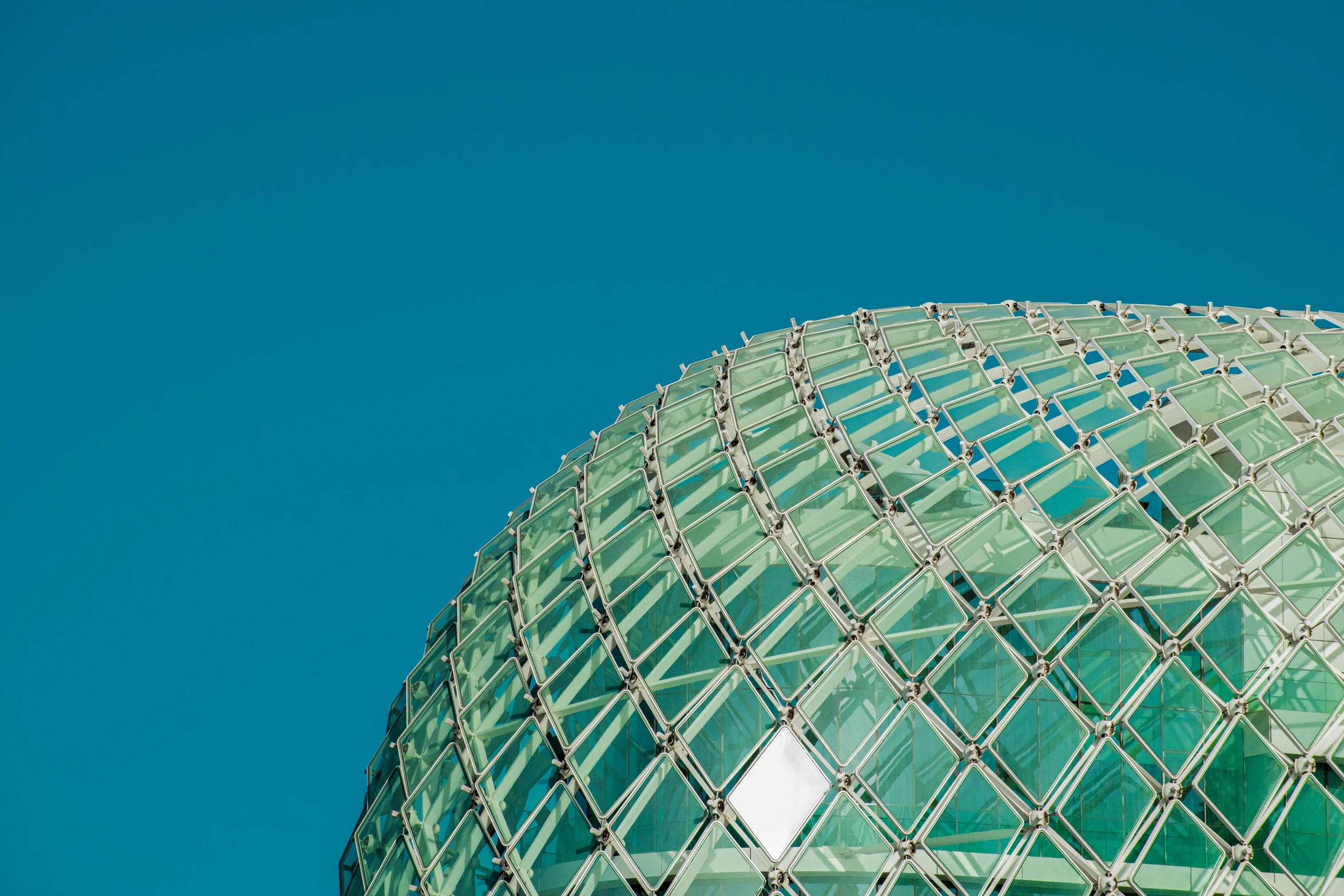 a large glass structure sits atop the sky