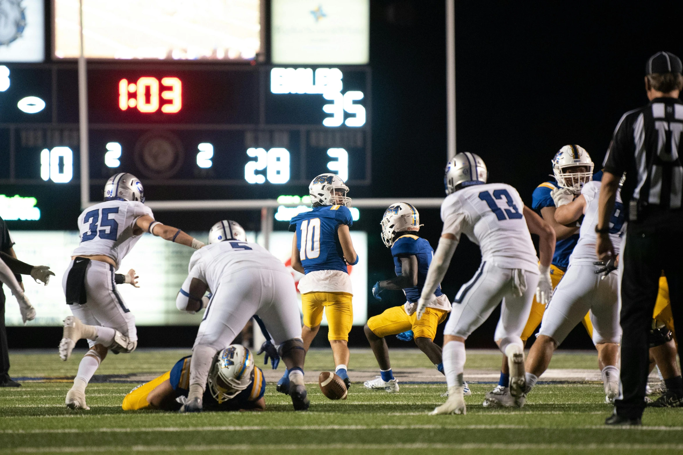 an image of some football players and one on the ground