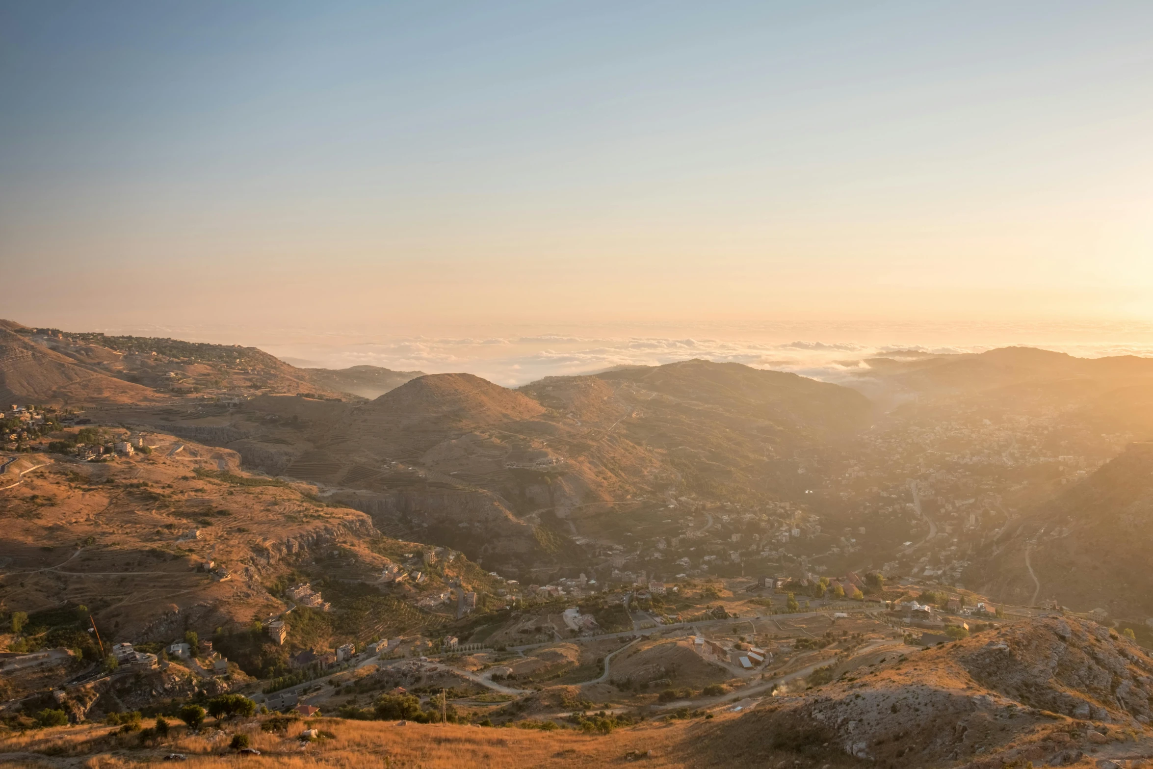 a bench is on top of a hill overlooking the city