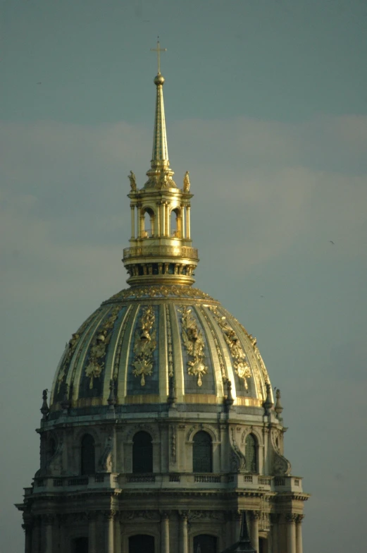 a tall gold dome atop an old building