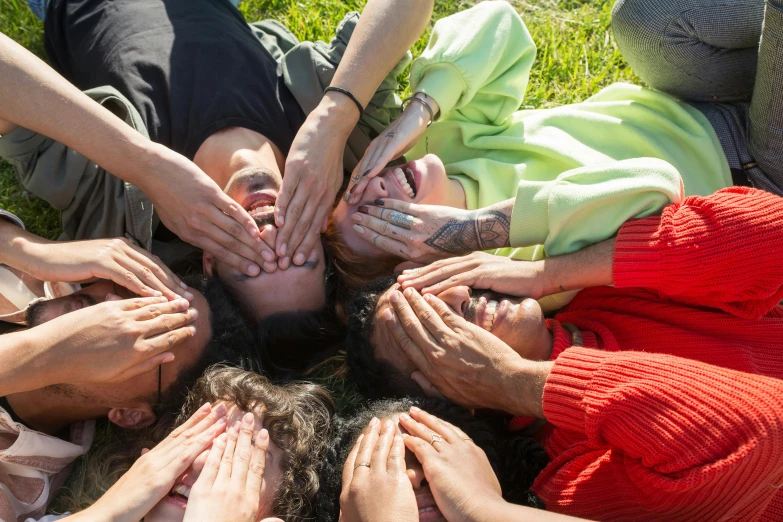 a group of people who have their hands around each other