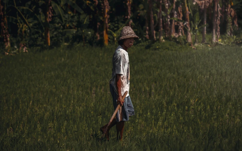 a person standing in a field with a paddle