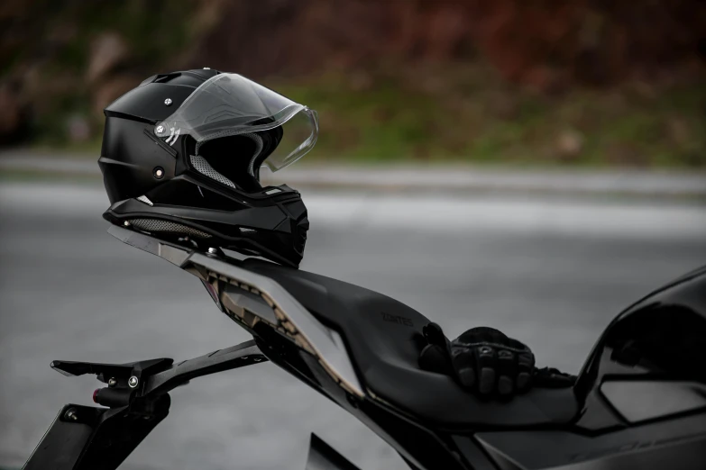 the helmet is set on top of the parked motorcycle