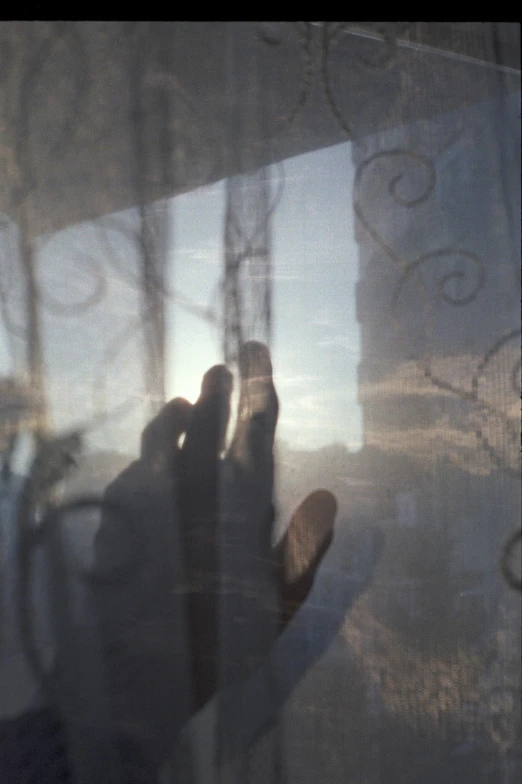 blurry reflection of a pair of feet from a window