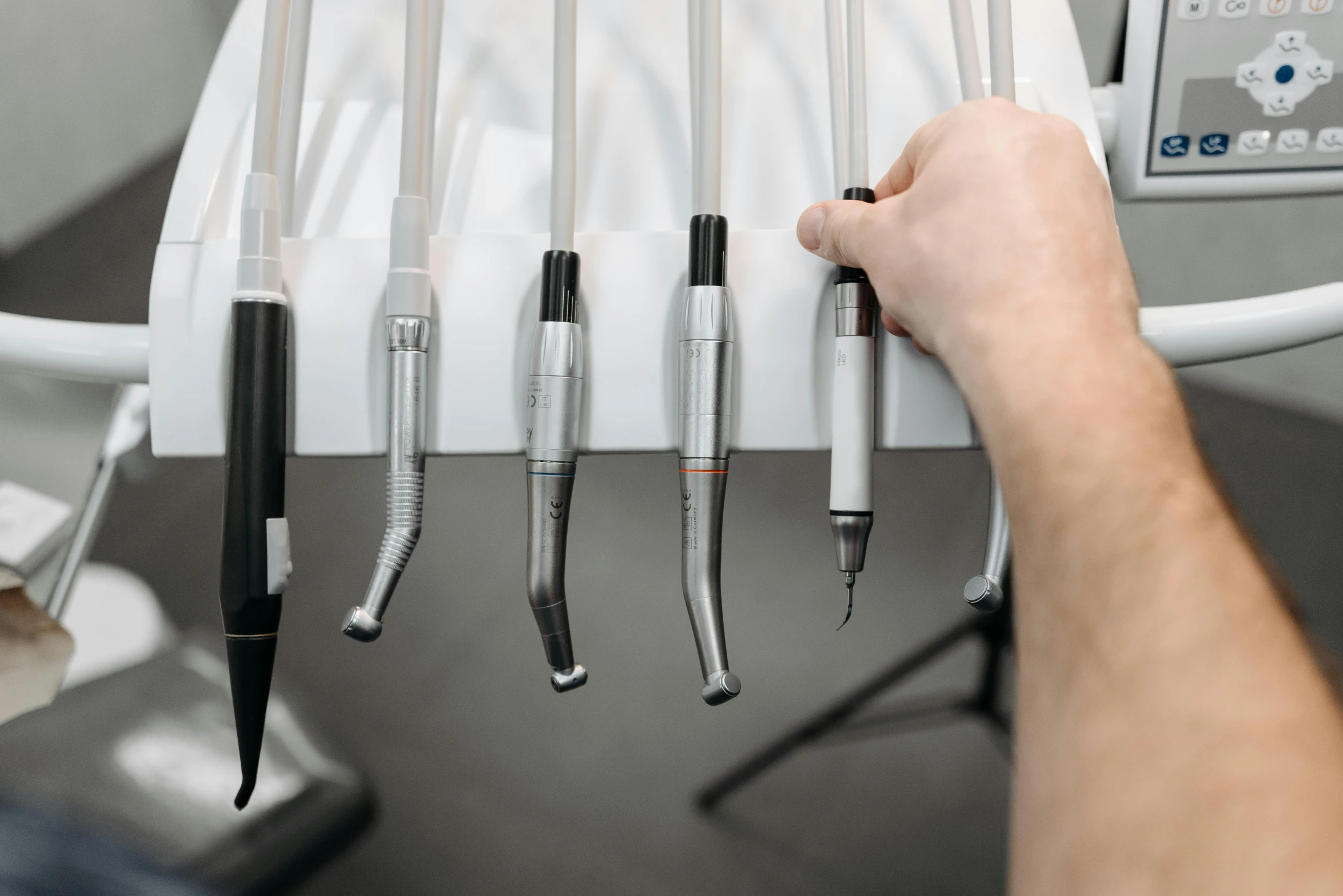 an image of several different medical tools hanging on a rack