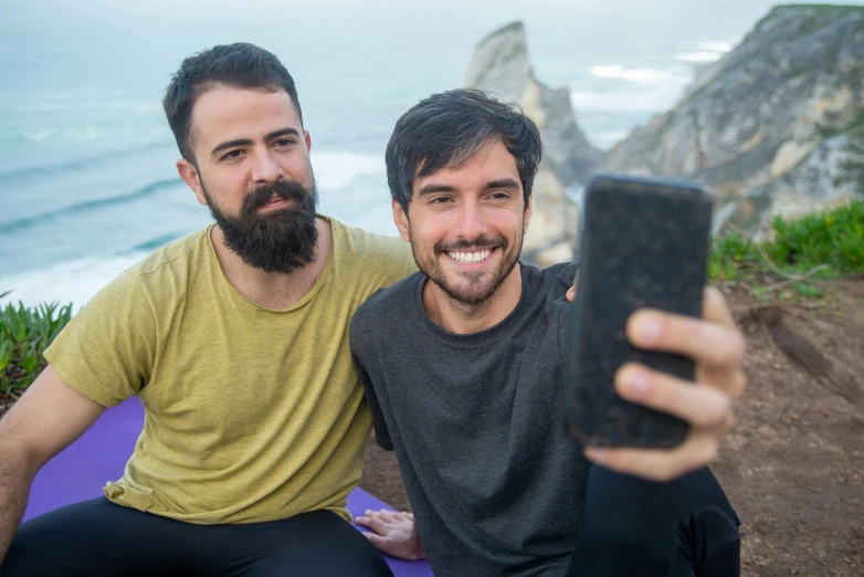 two men taking a selfie while posing together