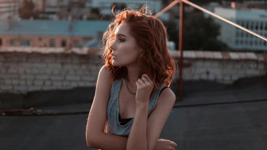 the young woman poses for a po on top of a roof