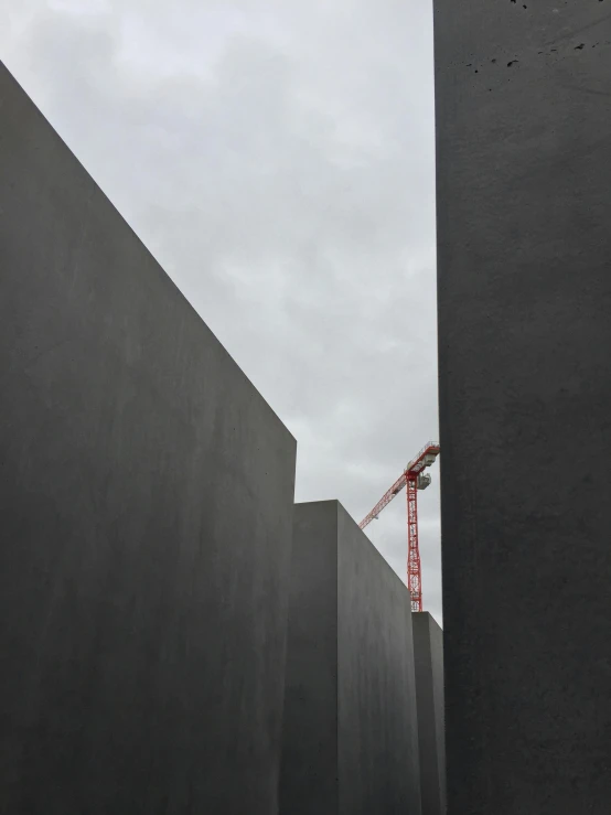 red crane in the background of a dark grey building