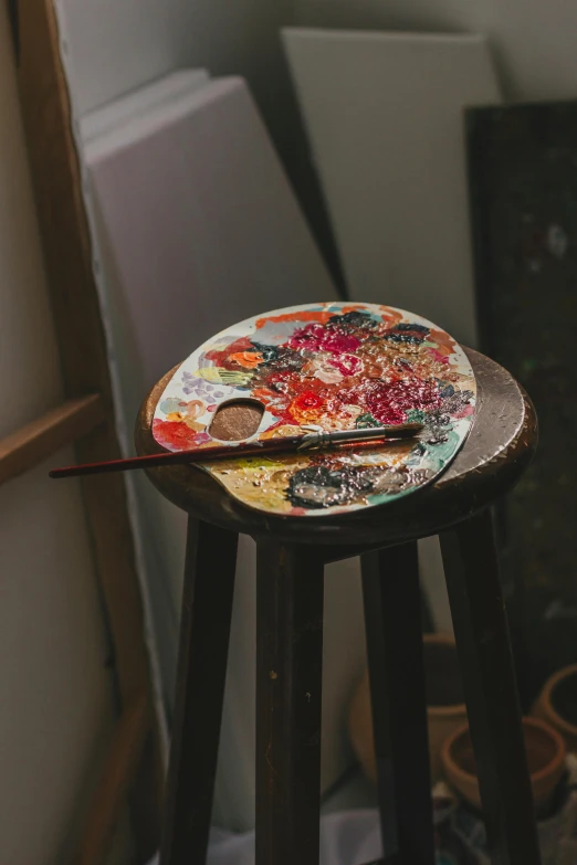 a brush sits on top of a painted plate