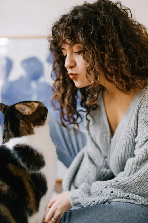 the woman is petting her cat that has turned brown