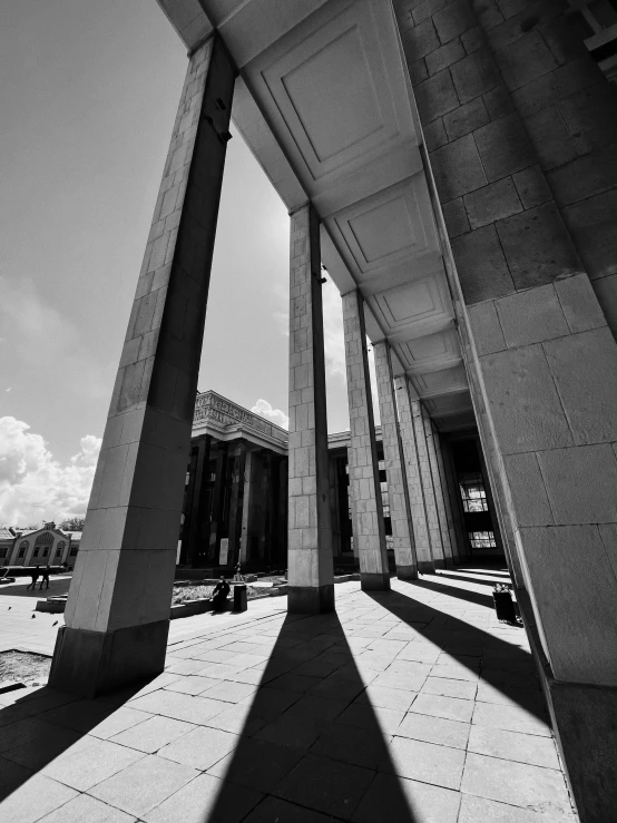 the sun casts a shadow on a building with two pillars