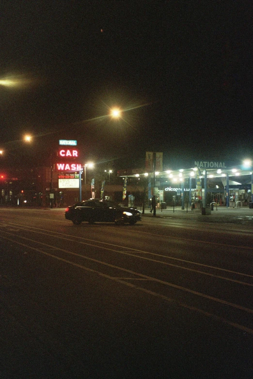 a car parked next to a gas station