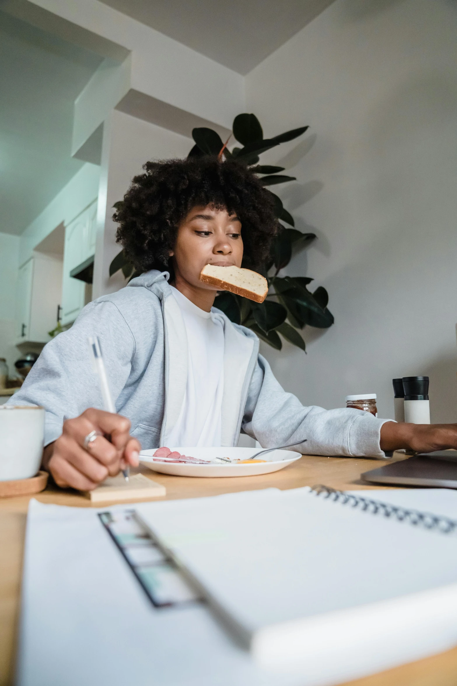 there is a person at a desk eating soing with a fork