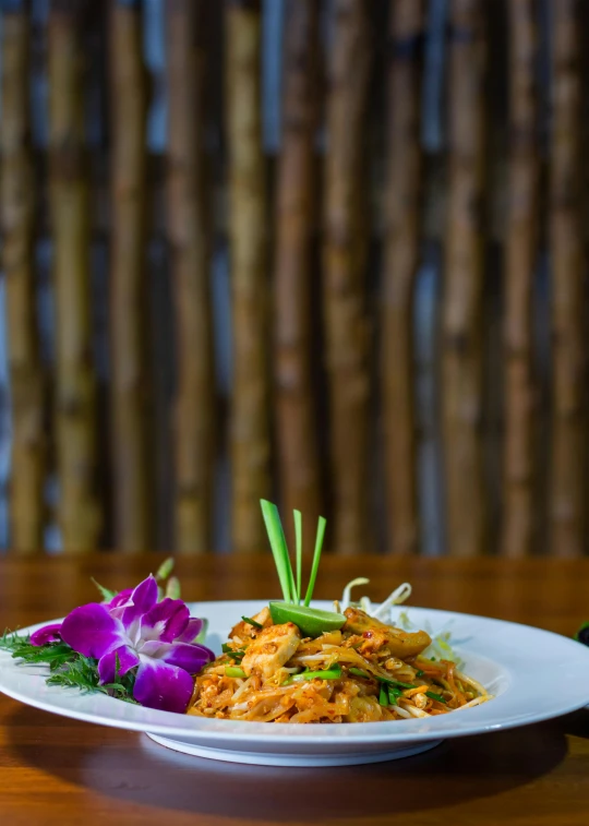 a plate with food that includes some flowers on top