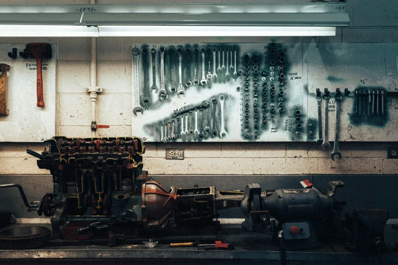 tools on a counter with lots of tools hanging above them