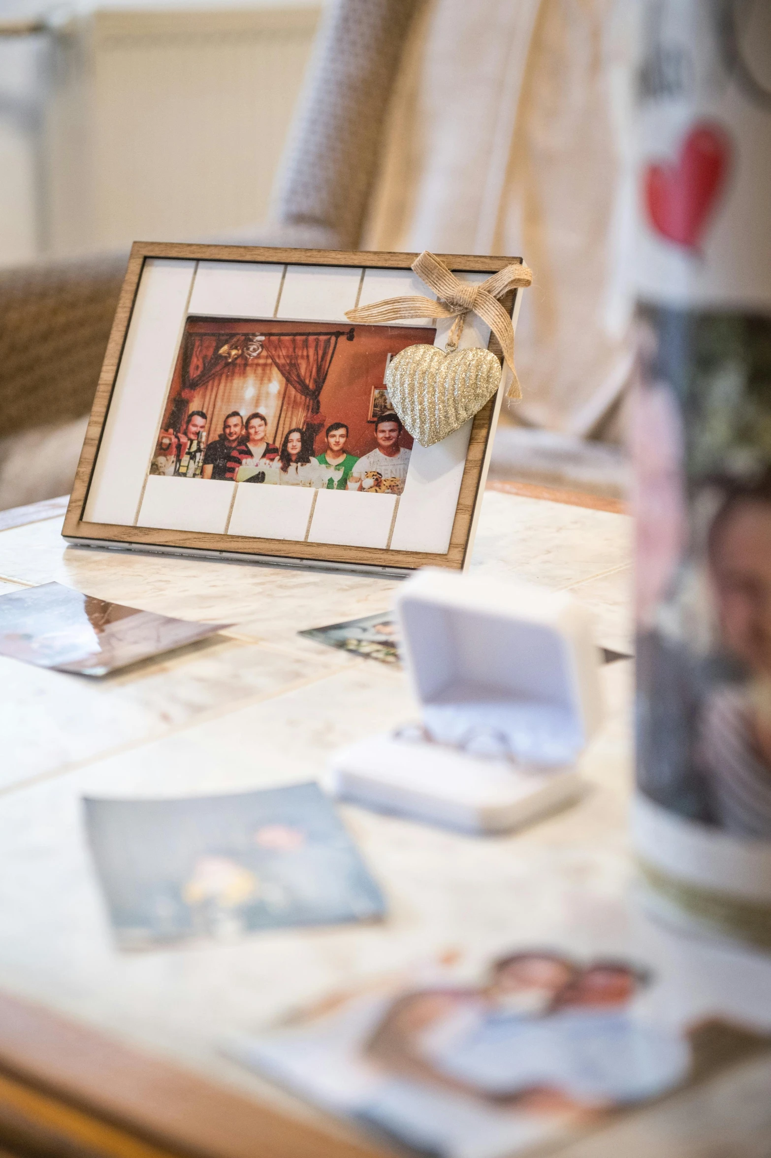 an easel table containing various pictures and a vase