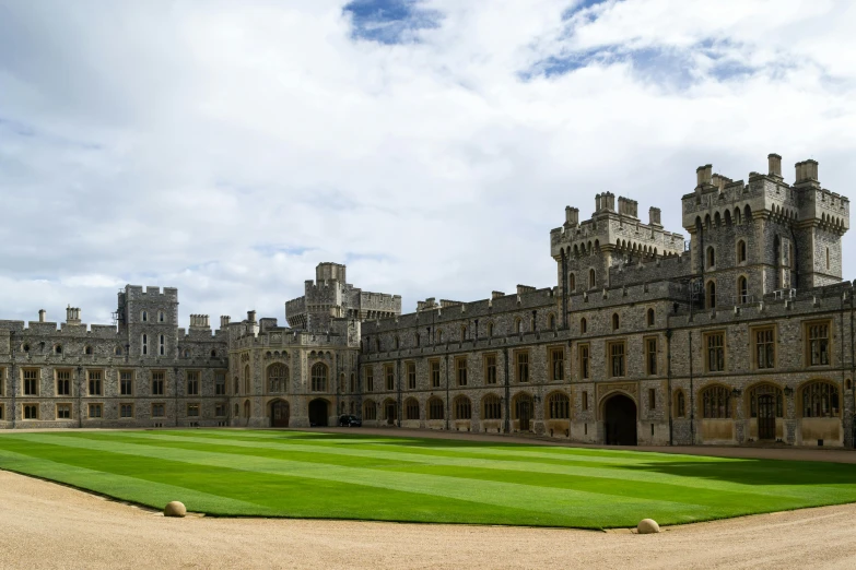 there is a building that has a green lawn on it