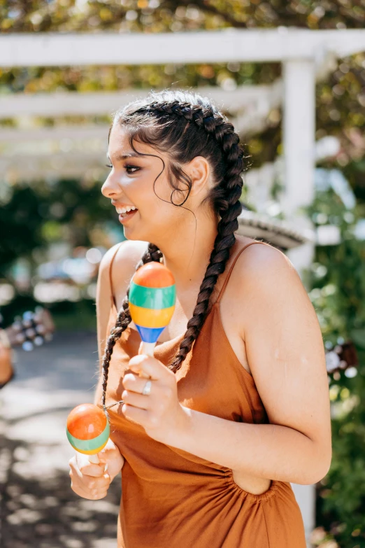 a woman holding two colored wooden toy