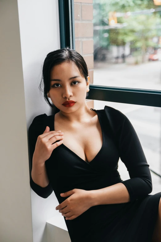 a woman is leaning on a ledge with her hands under her stomach